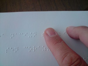 Person reading Braille book